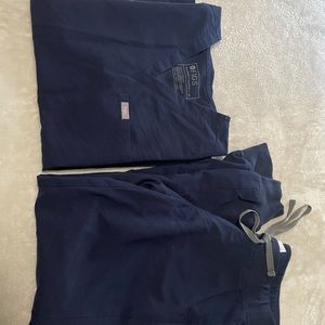 Navy Catarina one-pocket scrub top and navy Zamora jogger scrub pants